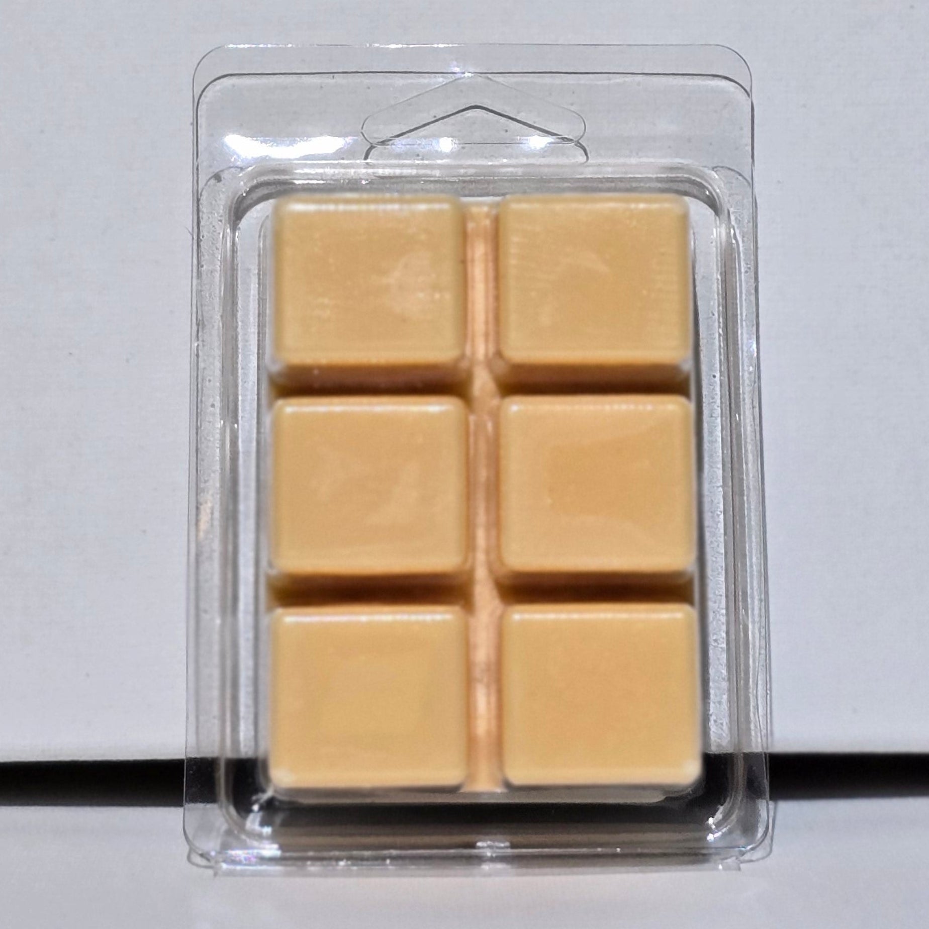 Pack of yellow wax melts on a white background